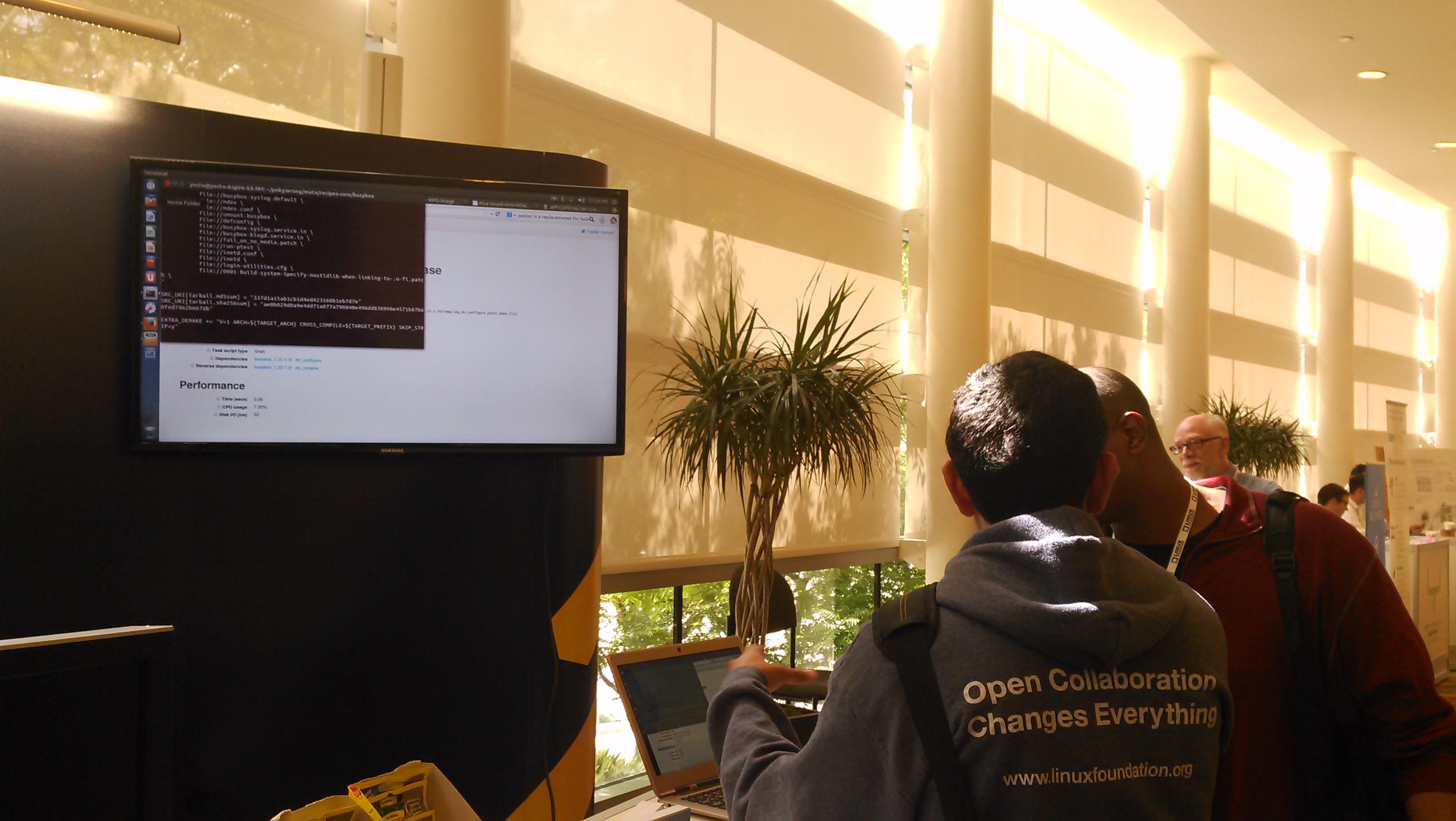 An OpenEmbedded maintainer runs an impromptu training session at the Yocto Project booth during an Embedded Linux conference.